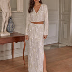 A brunette model wearing a sequin two-piece bridal cropped blouse and maxi skirt.