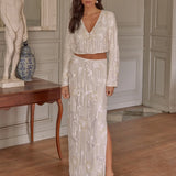 A brunette model wearing a sequin two-piece bridal cropped blouse and maxi skirt.